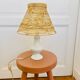 White porcelain table lamp and vintage raffia lampshade