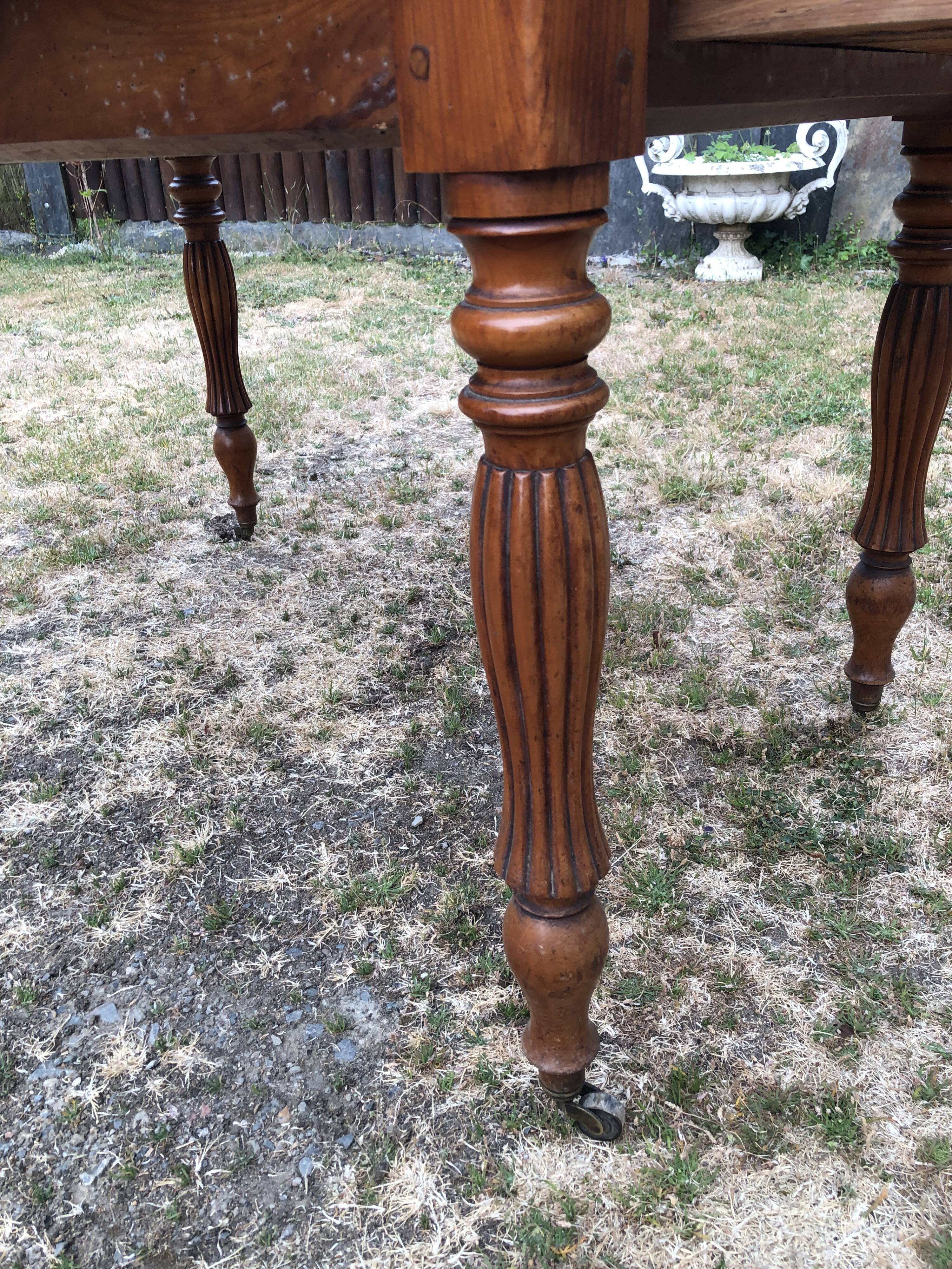 Louis Philippe oval drop-leaf table in solid cherry wood with 2 drawers.