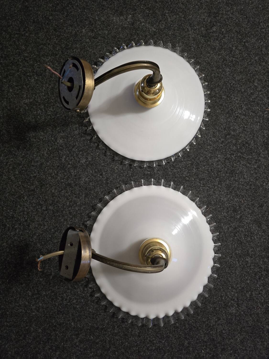 Wall sconces with scalloped opaline lampshades.