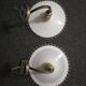 Wall sconces with scalloped opaline lampshades.