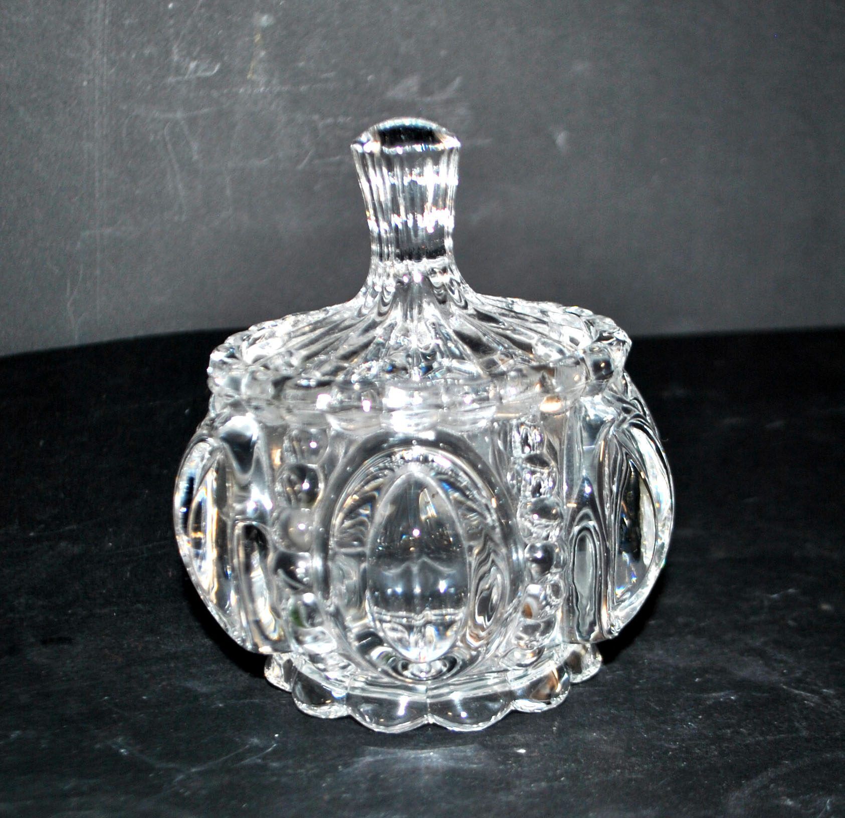 Thick moulded crystal sugar bowl with a beaded and medallion design.