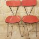Pair of red tublac formica chairs with chrome metal legs