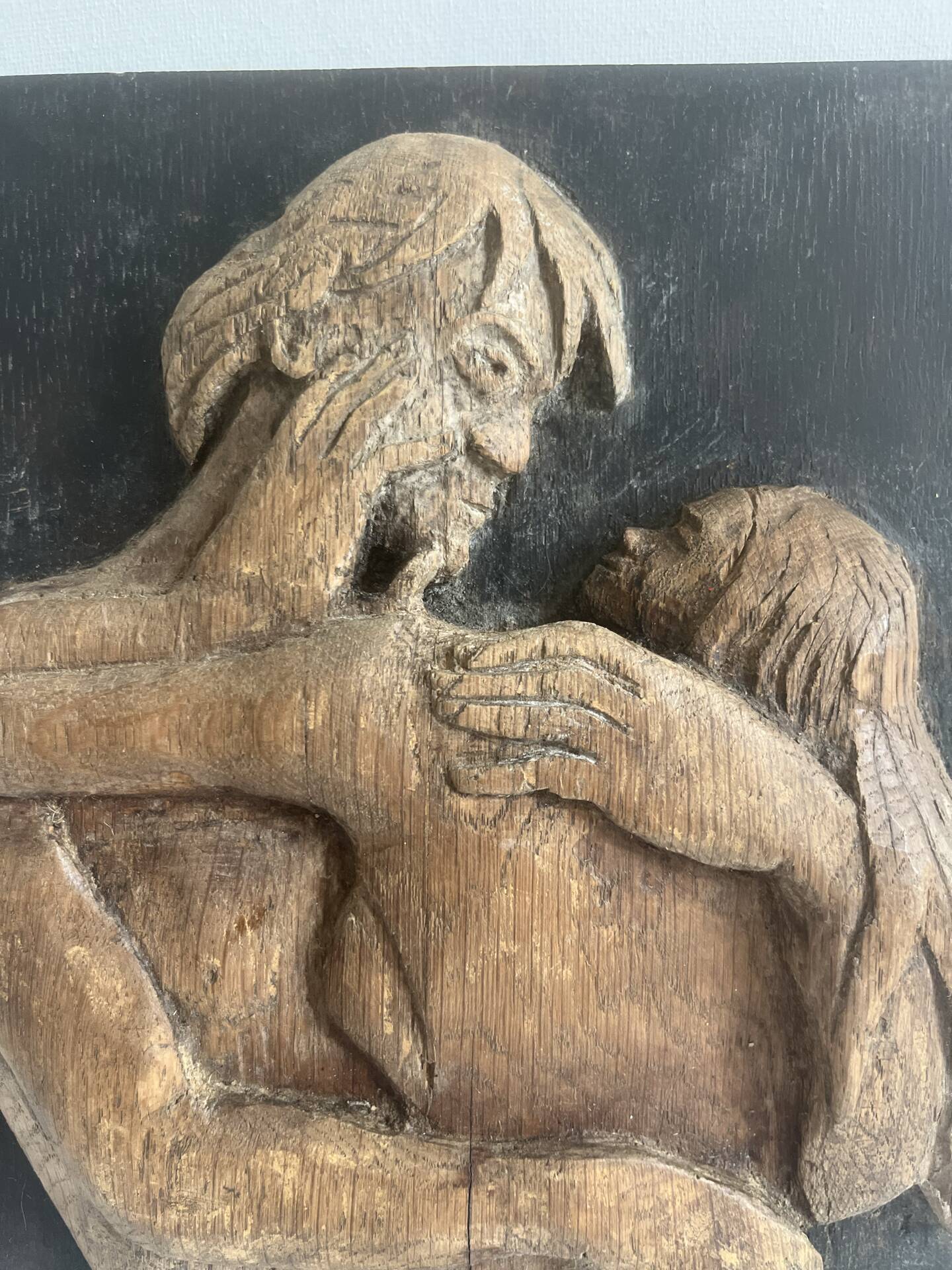 Wood sculpture bas-relief of man, woman, and child, signed.