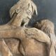 Wood sculpture bas-relief of man, woman, and child, signed.