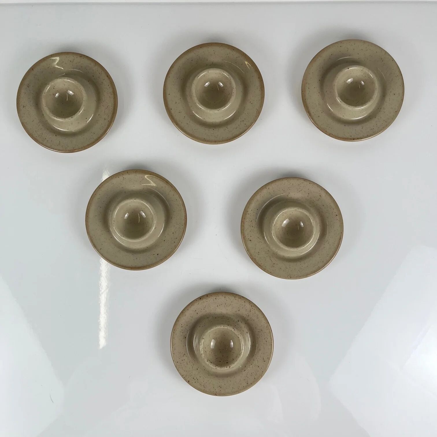 Set of 6 speckled beige ceramic egg cups.