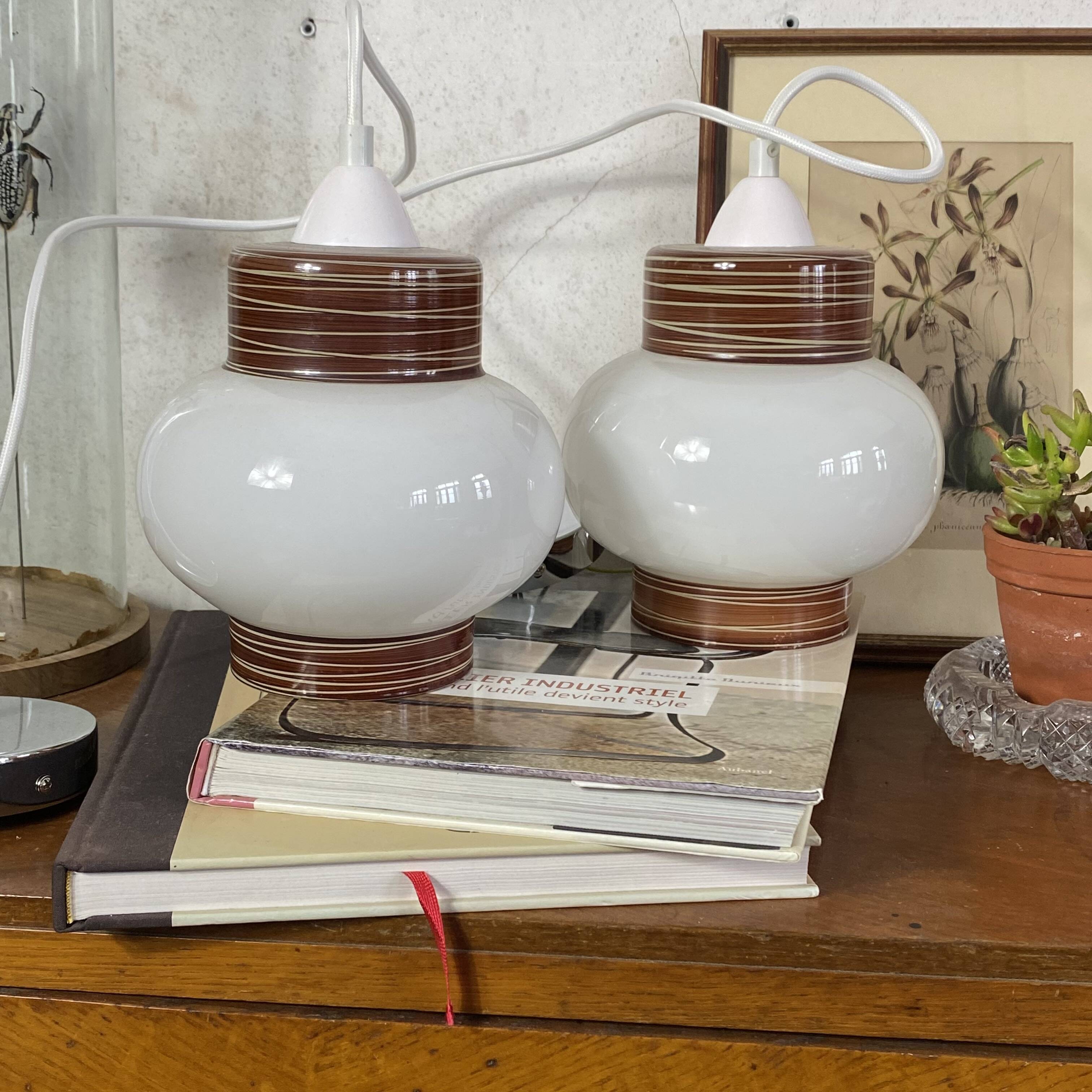 Pair of pendant lights with white glass shades from the 1950s.