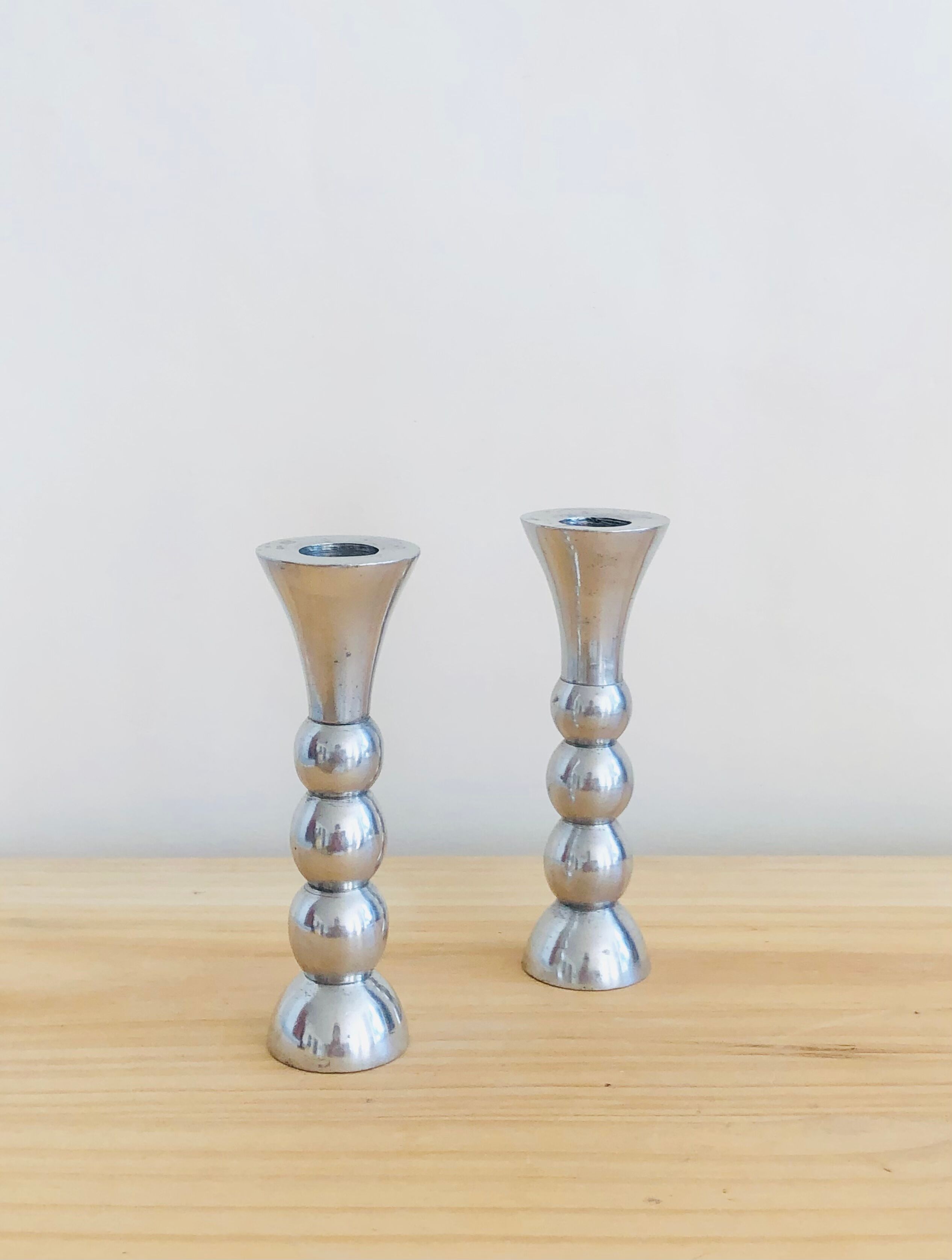 Pair of vintage cast aluminum candle holders