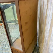 Louis XV style display cabinet in cherry wood with a mirrored back and glass shelves.