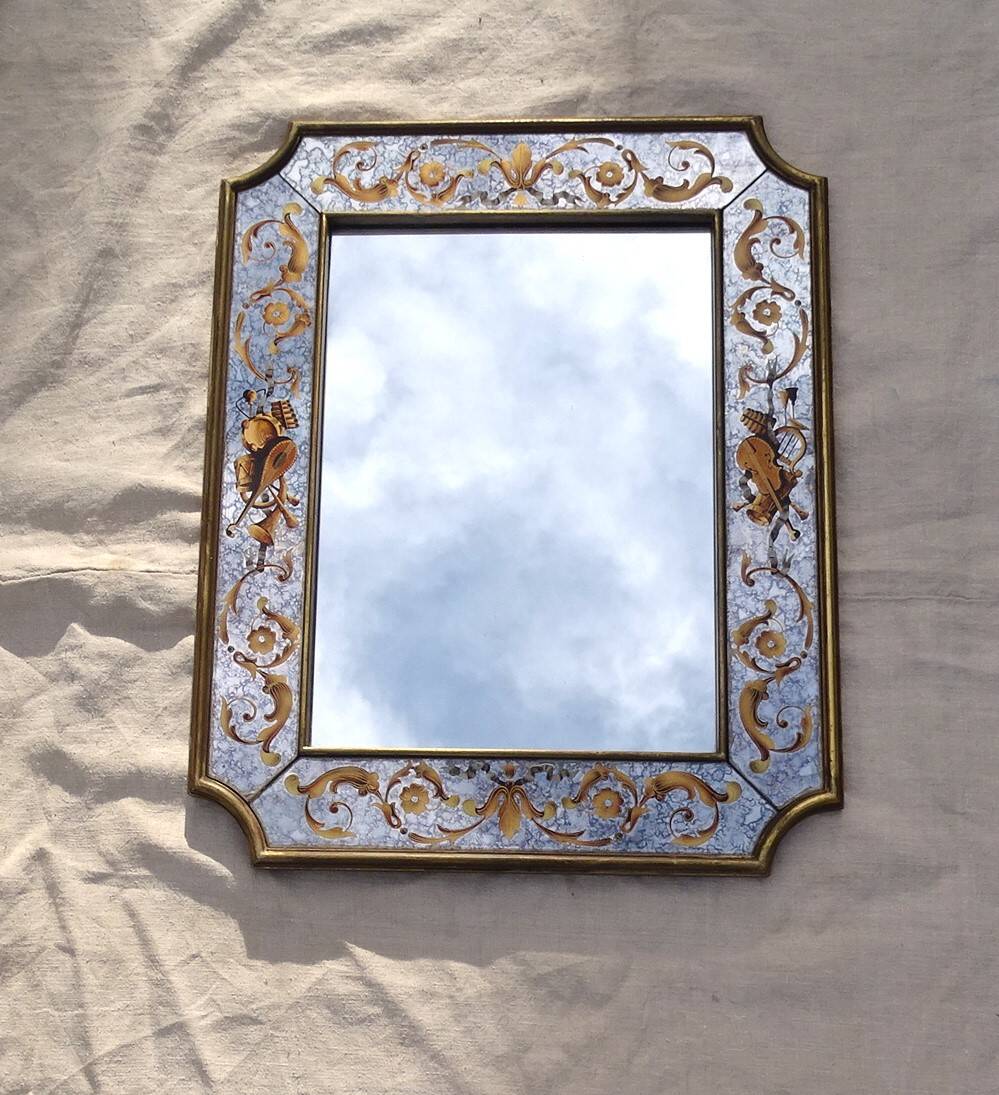 50s Eglomisé glass mirror with musical instrument decor