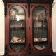 Large display cabinet in walnut veneer and blackened wood, 19th century.