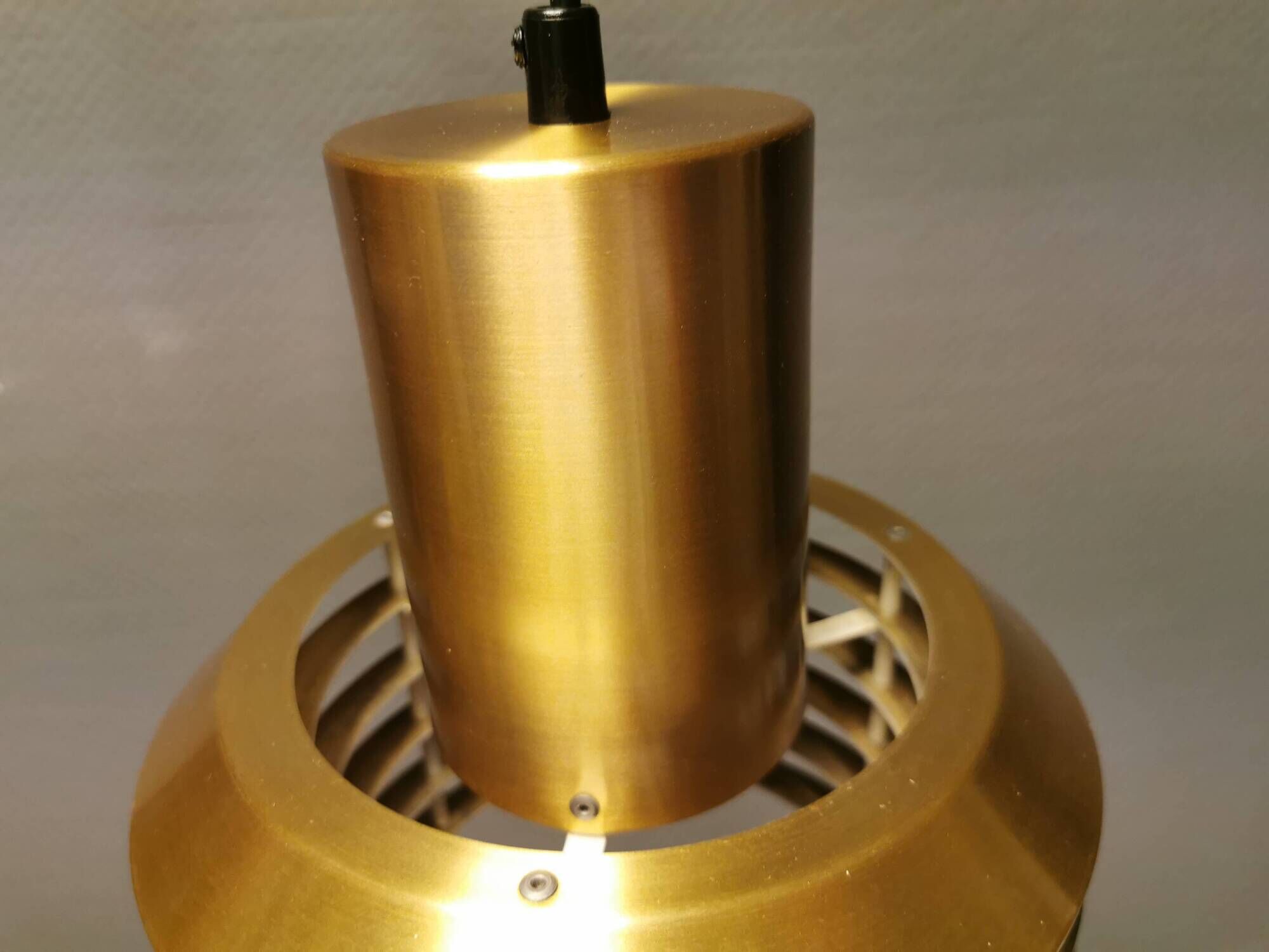 Hanging lamp in gold-colored aluminum with many layers of shades.