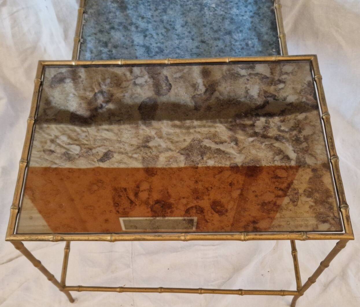 Pair of vintage nesting tables in faux bamboo with a gold finish – distressed mirrors