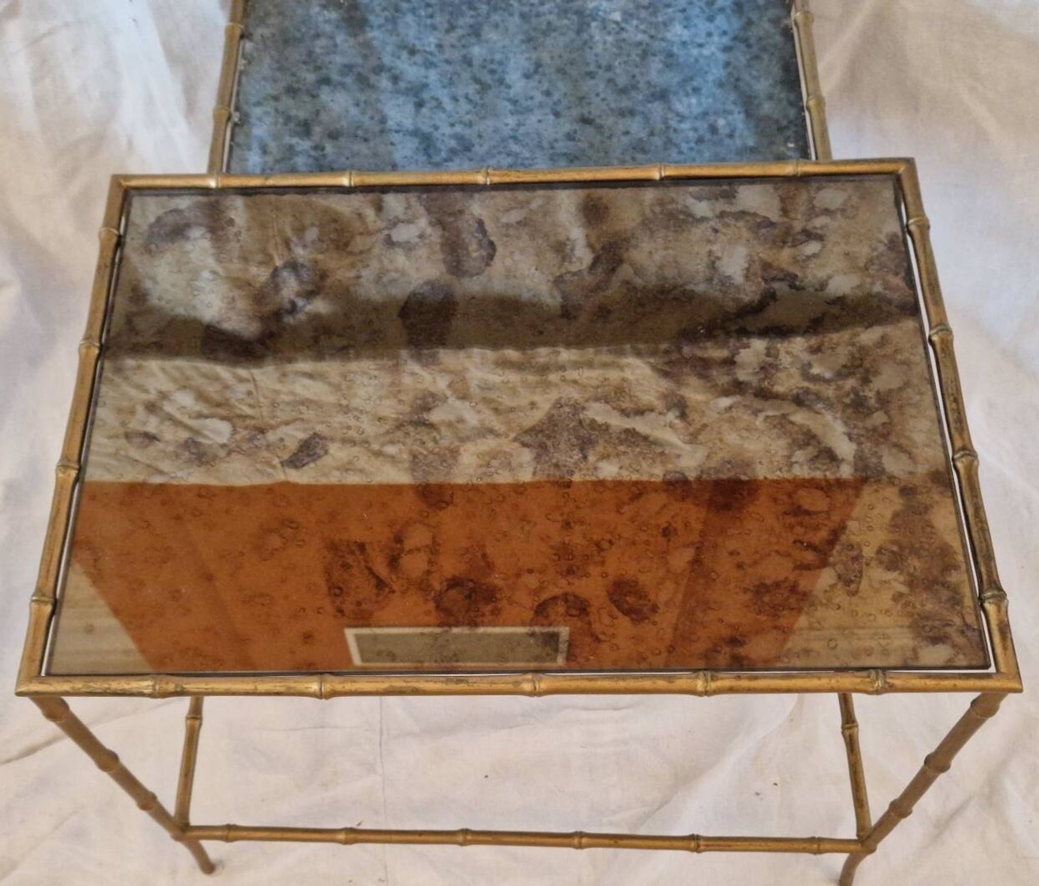 Pair of vintage nesting tables in faux bamboo with a gold finish – distressed mirrors