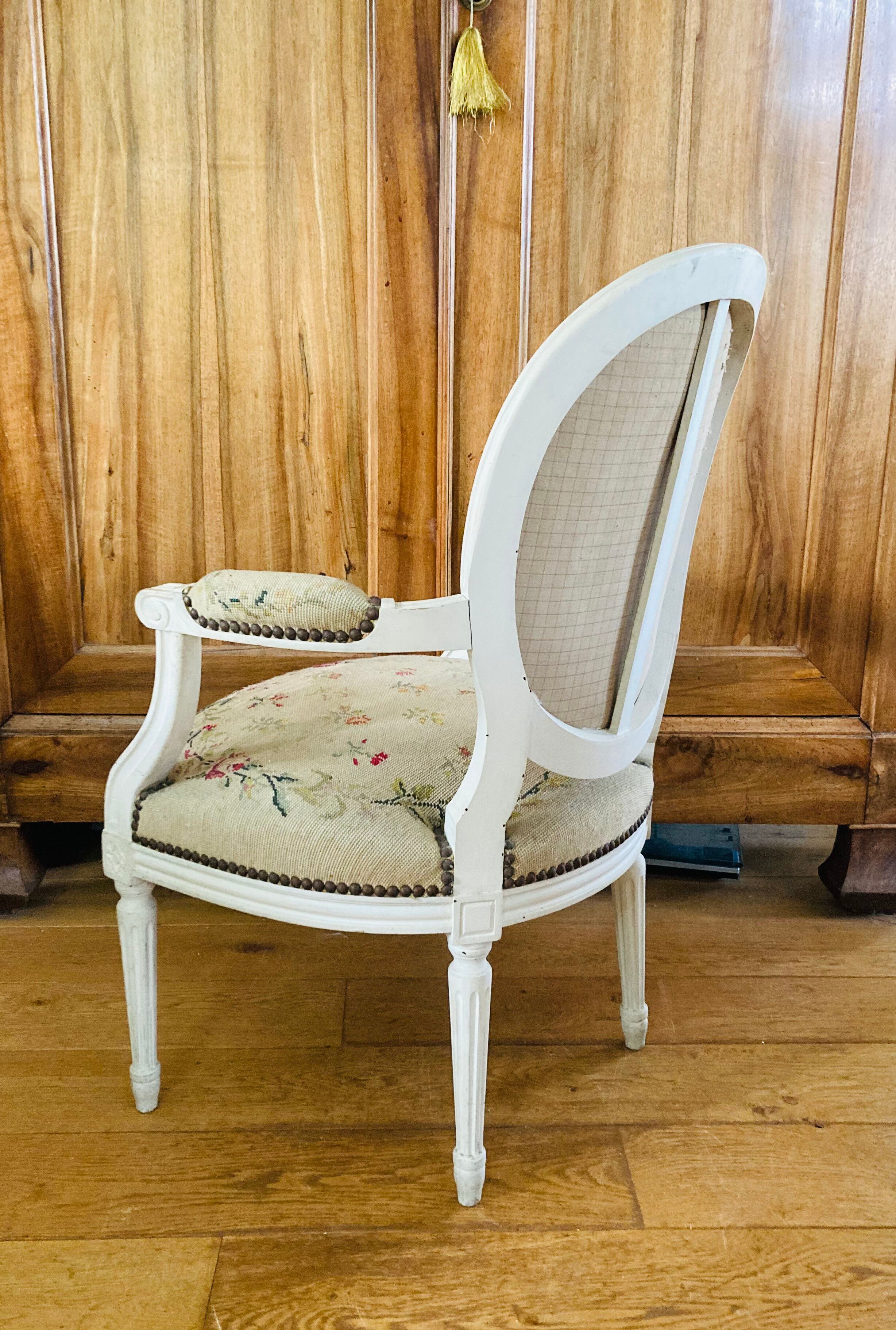 Upholstered armchair with cross-stitch in the Louis XVI style, 19th century.