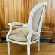 Upholstered armchair with cross-stitch in the Louis XVI style, 19th century.