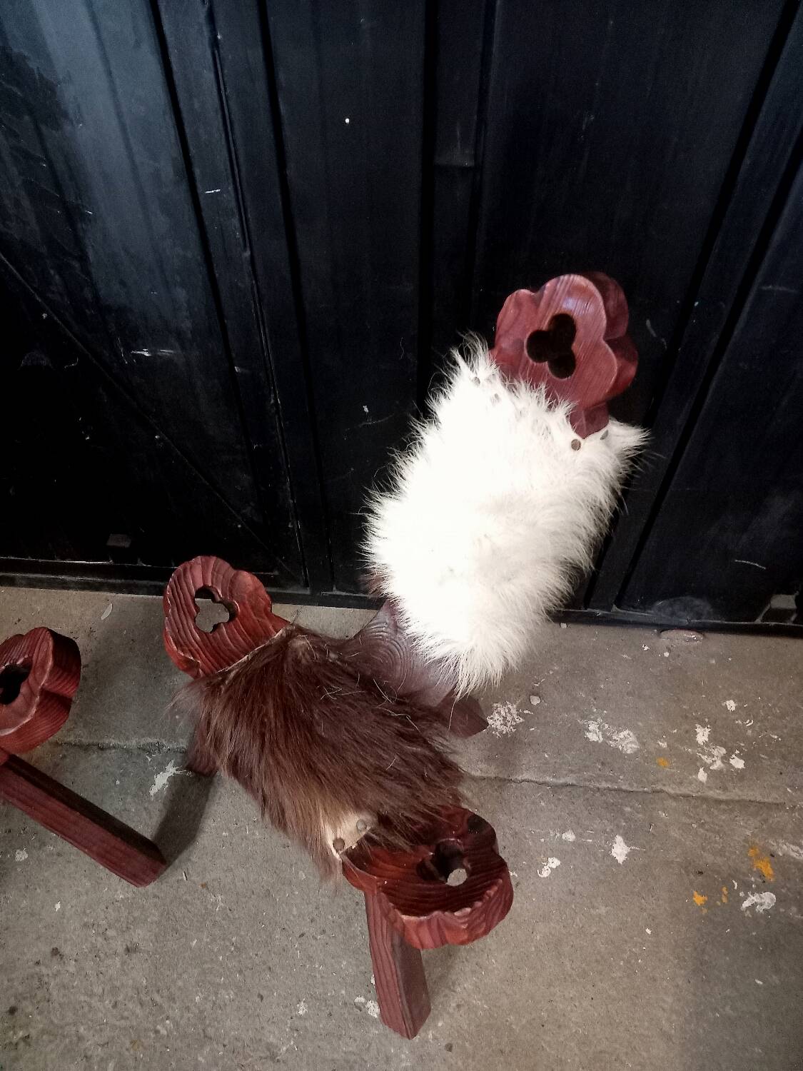 Pair of brutalist tripod chairs in wood and cowhide