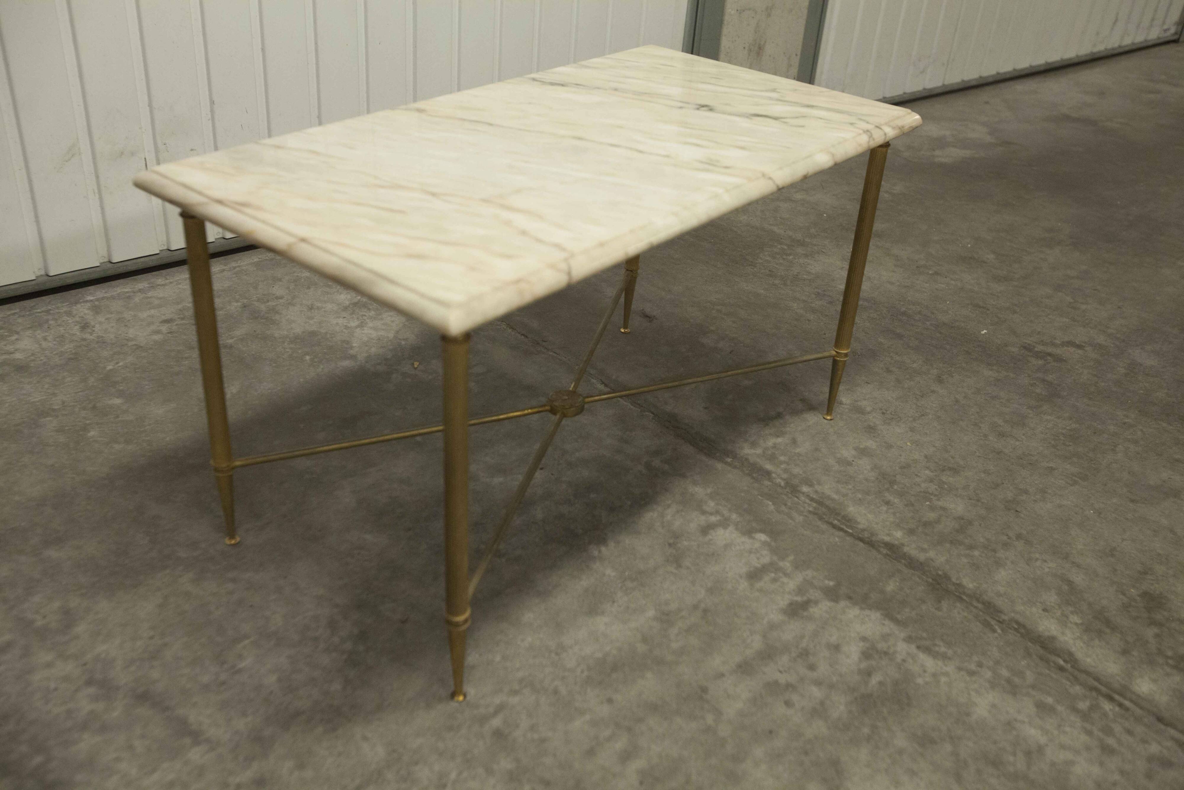 Marble coffee table with brass legs, height 46 cm.