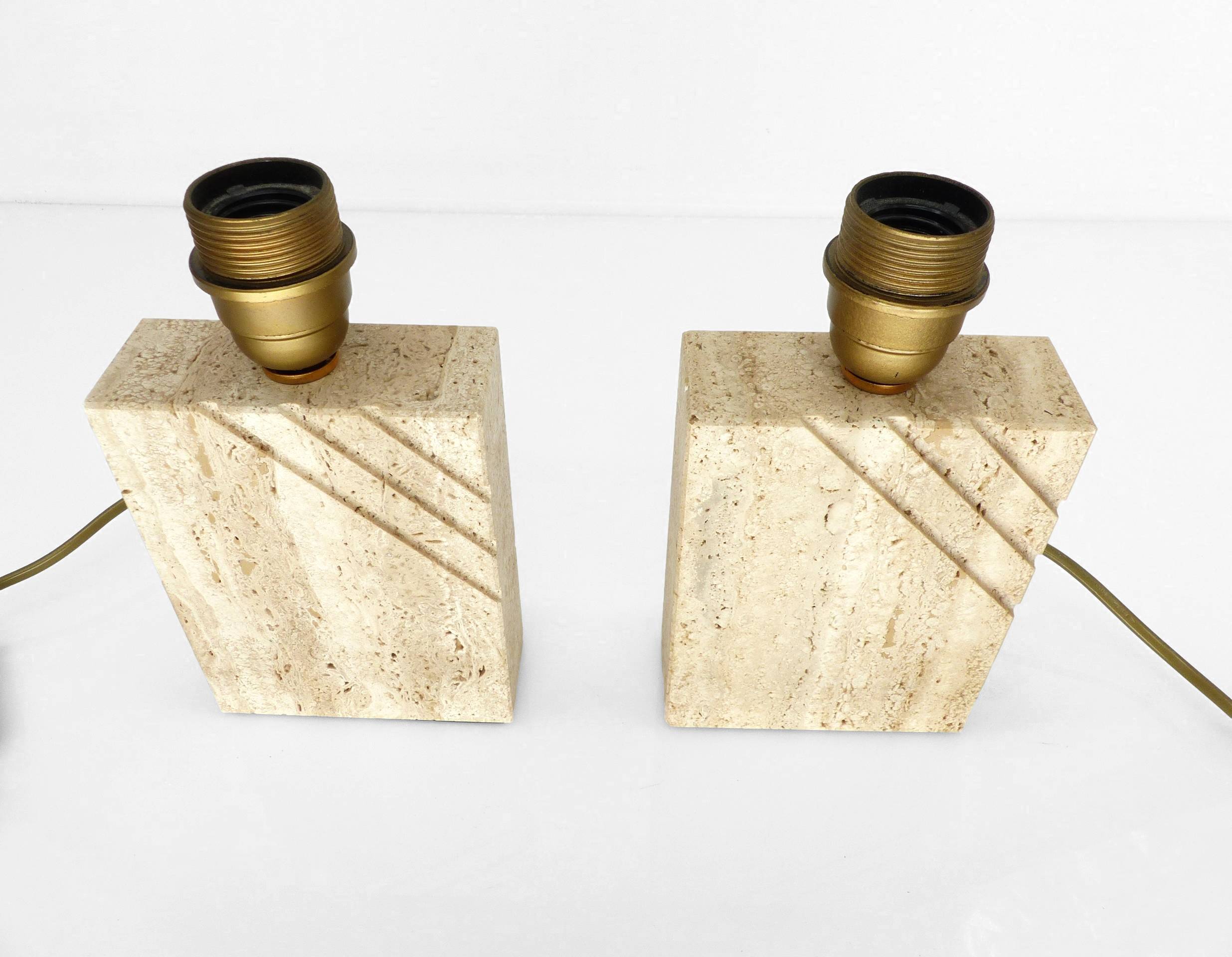 Pair of solid travertine table lamps with incised decoration, French production.