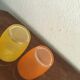 Four glasses in orange granités in orange and yellow