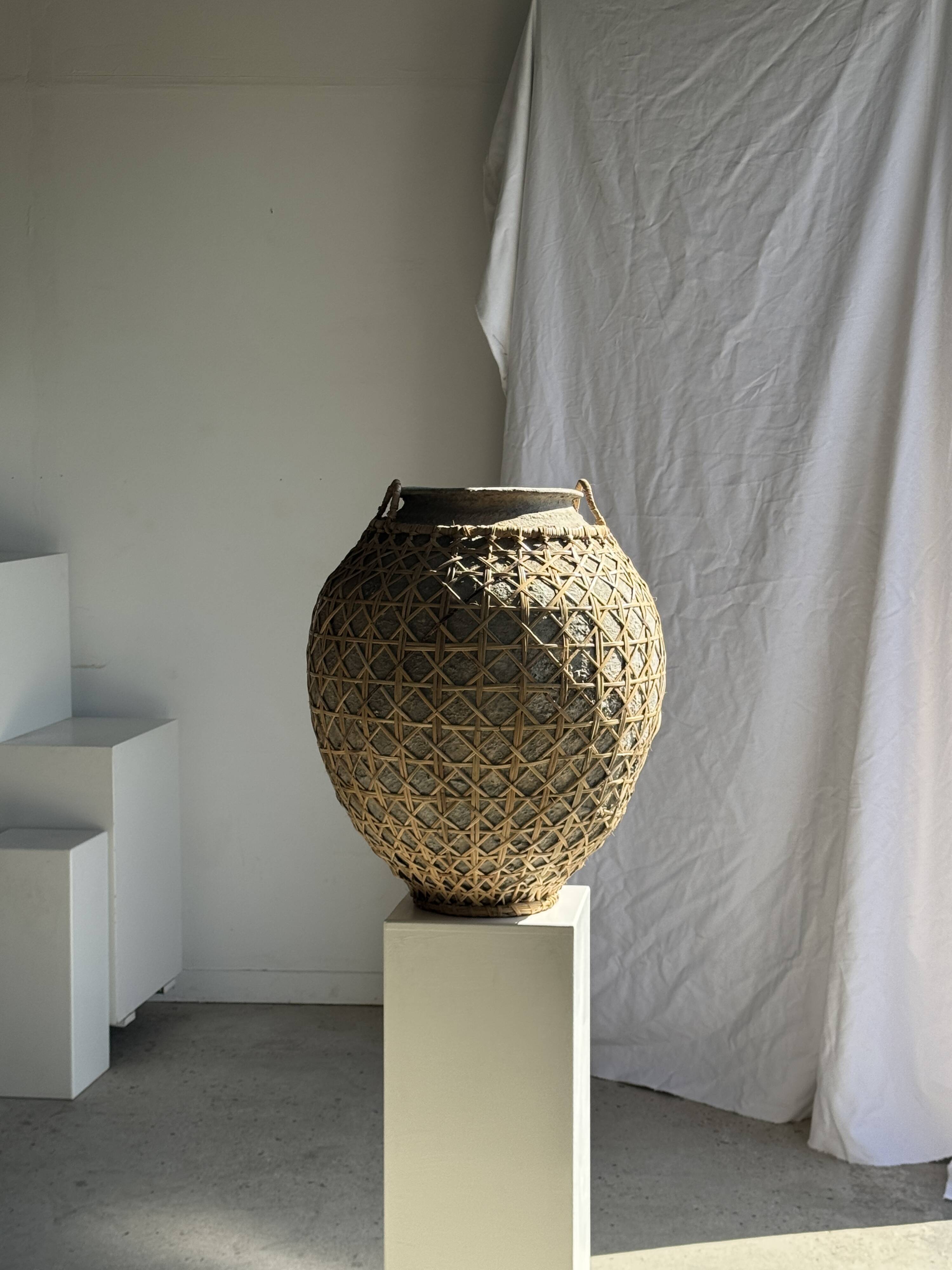 Immense light grey antique-style pot with a crosshatch lid and handles.