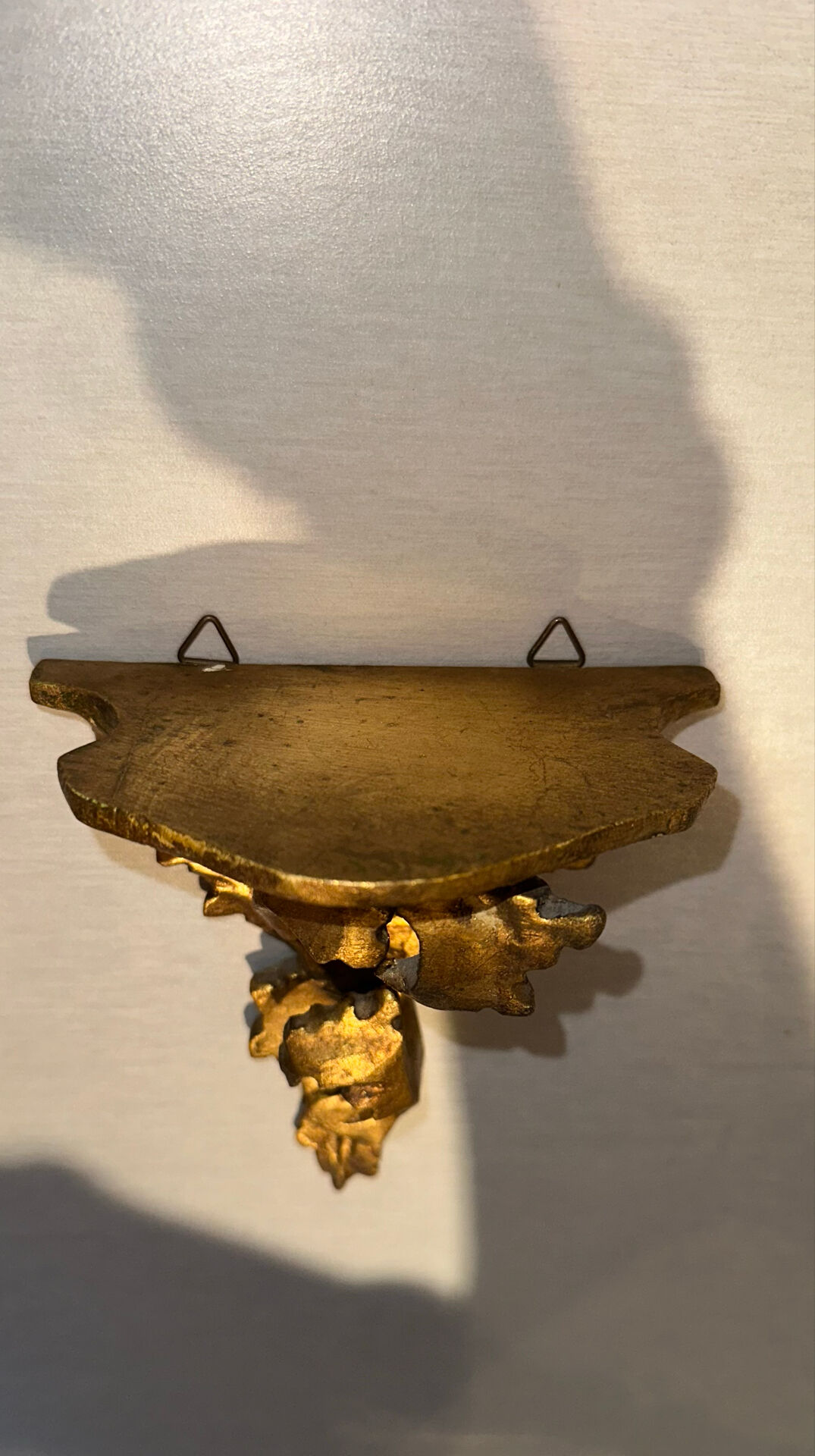 Antique wall-mounted console in gilded wood in rococo style.