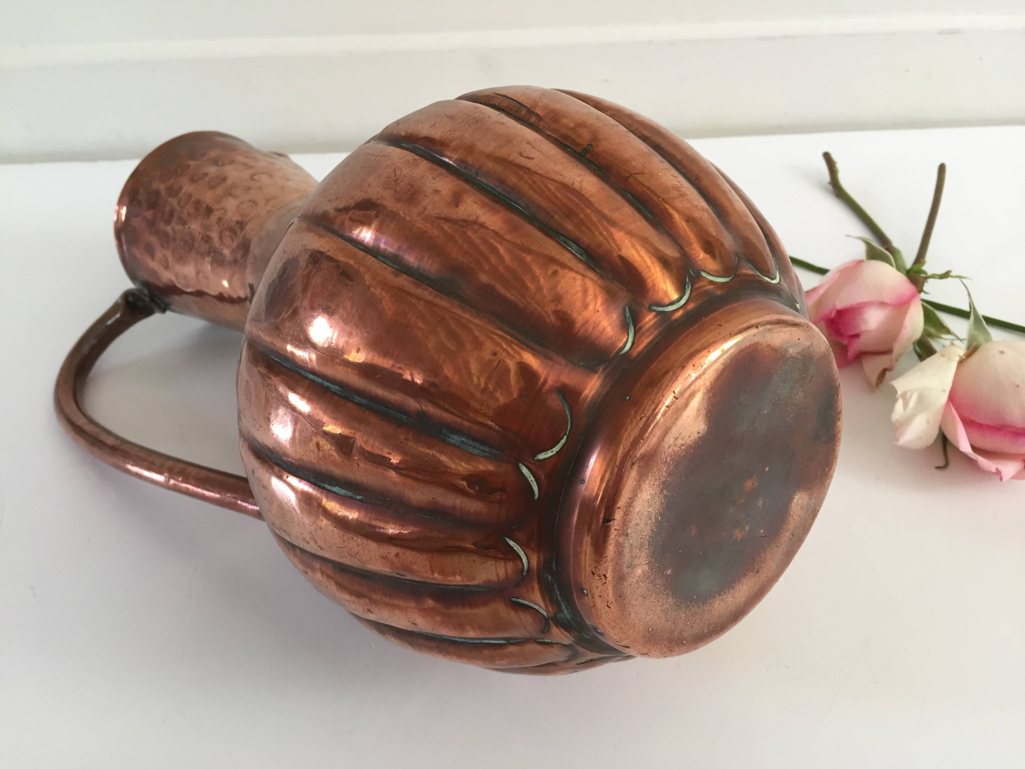 Pitcher-shaped vase in hammered copper