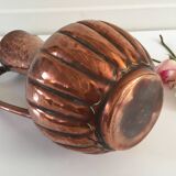 Pitcher-shaped vase in hammered copper
