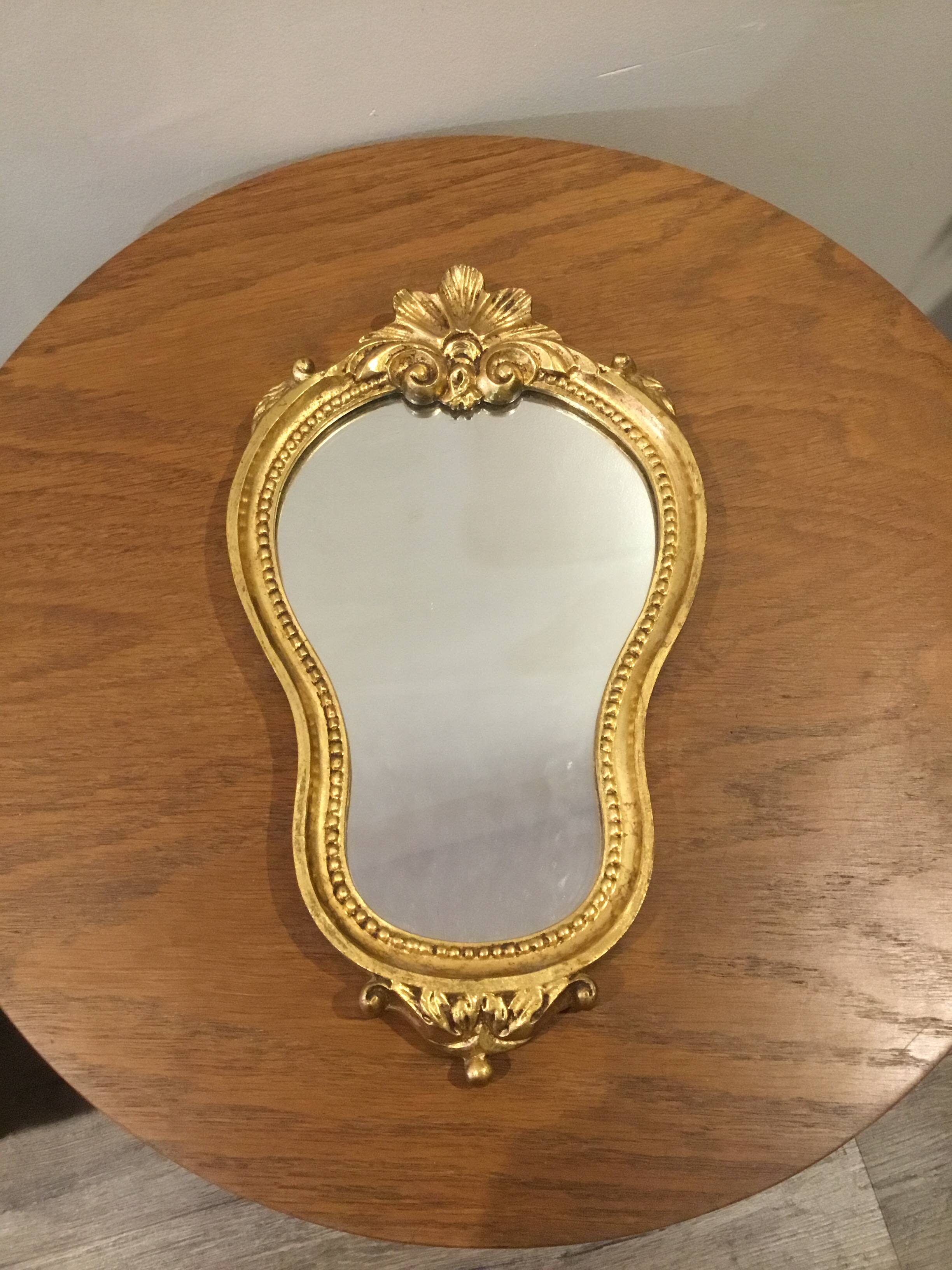 Golden wooden mirror in baroque style