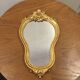 Golden wooden mirror in baroque style
