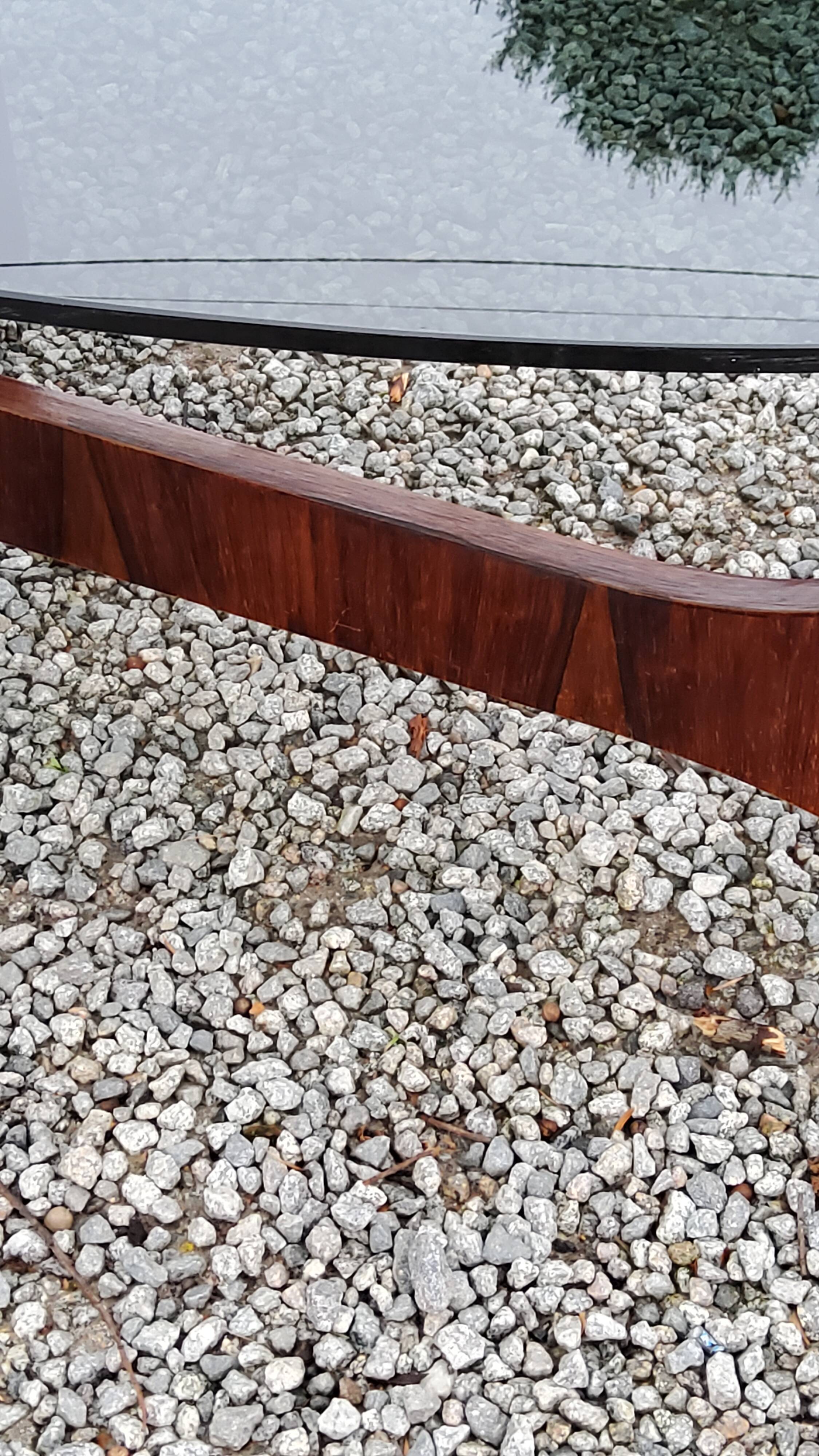 Designer coffee table by Hugues Poignant in rosewood and smoked glass from the 70s