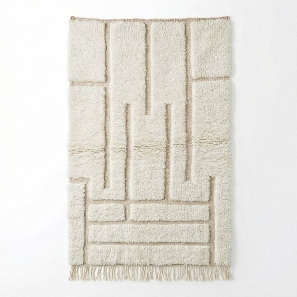 White Moroccan rug with a graphic pattern.