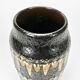 "Fat Lava" vase black background and colorful enamelled drippings