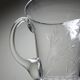 Antique glass pitcher with wheel engraving and floral decoration, Bohemia, early 20th century.