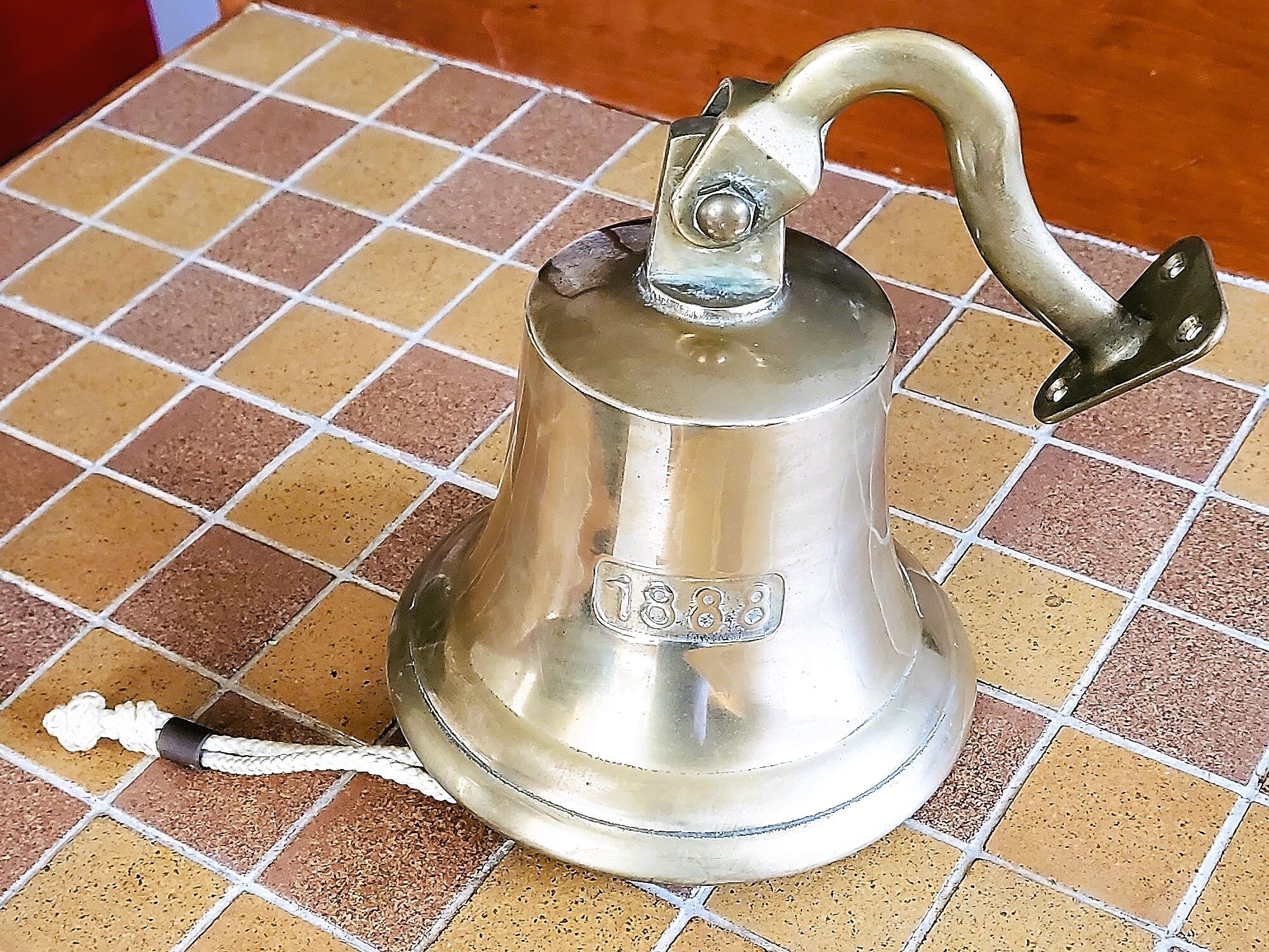 Polished brass bell with its stem