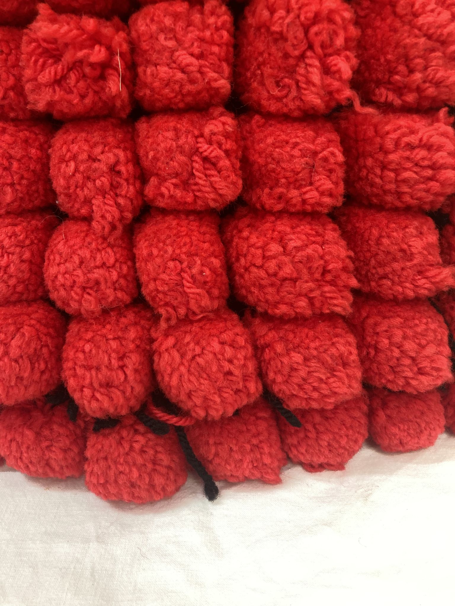 Vintage cushion red pompoms