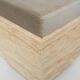 Cubic travertine stool with velvet cushion