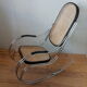 Rocking chair in chrome metal and wood