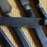 A set of 8 knives with black wooden handles