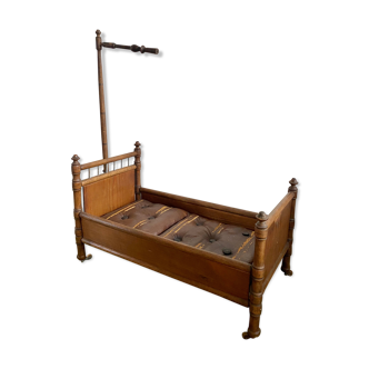 Antique wooden doll bed, sold by Au bon Marche