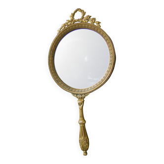 Antique hand-faced mirror in gilded bronze