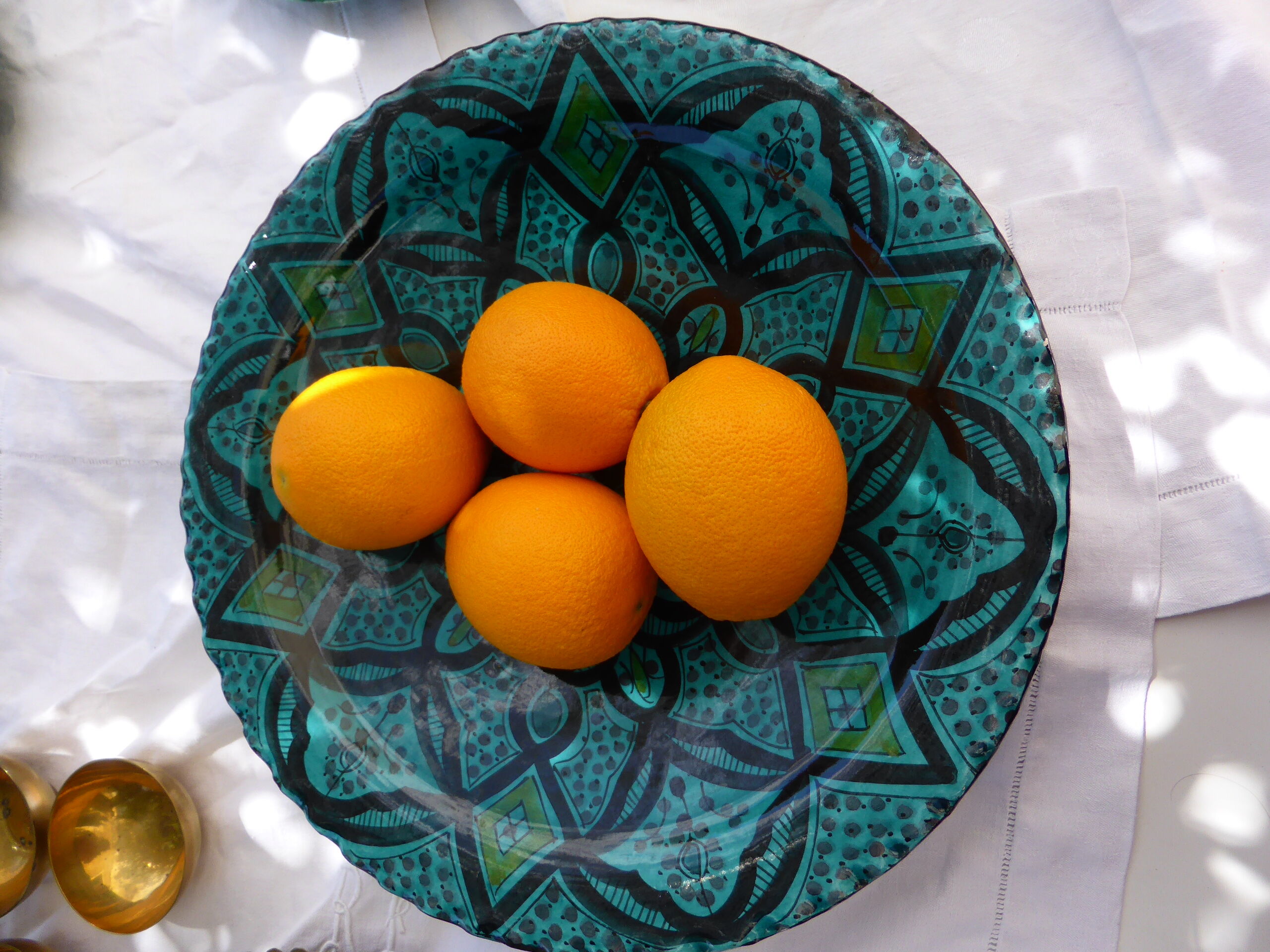 Hand-painted vintage oriental hollow dish, black patterns on a turquoise background
