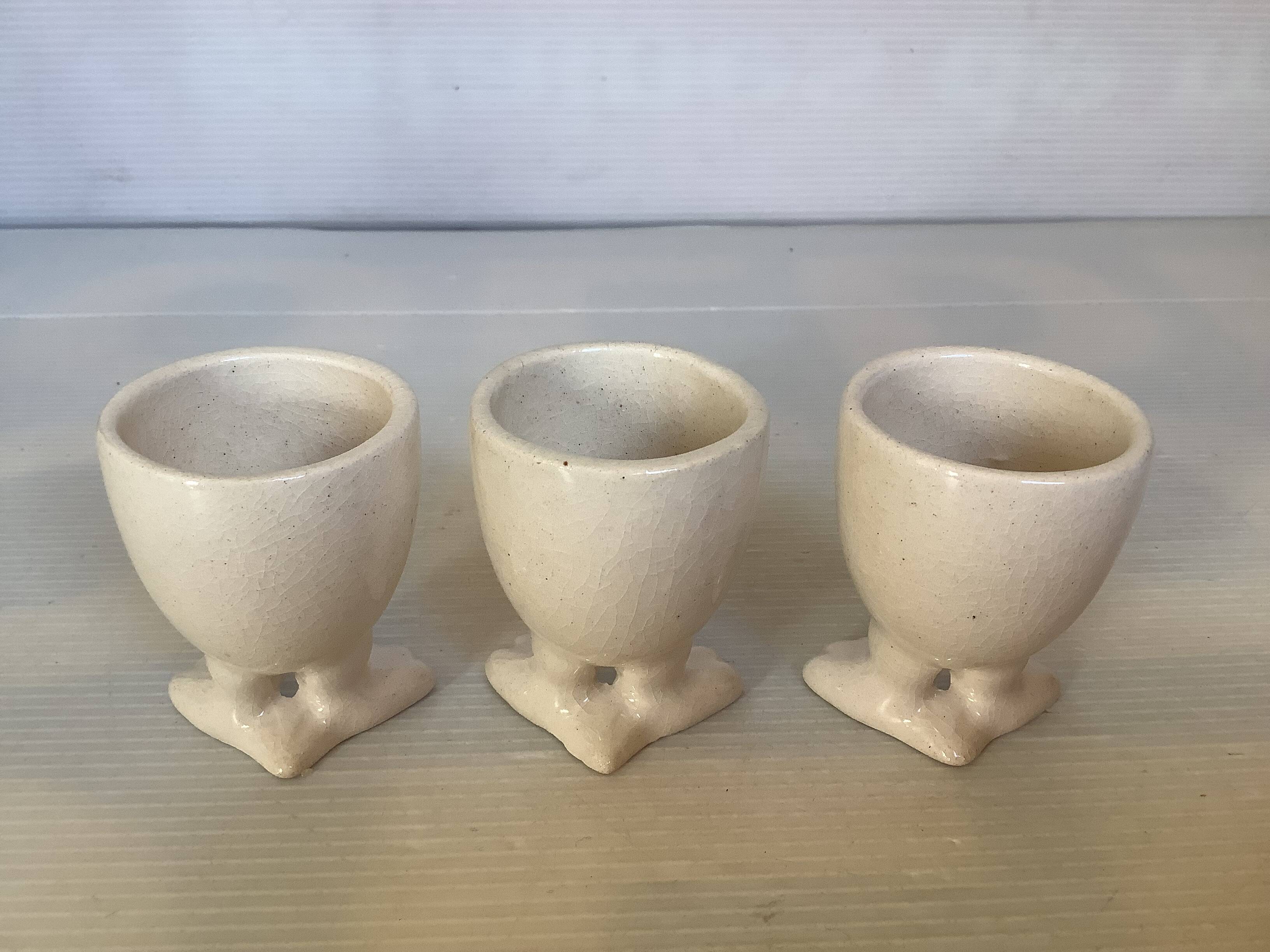 Set of cracked egg cups with feet