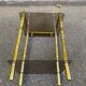 Vintage side table with smoked glass and sculpted golden brass, Hollywood Regency style.