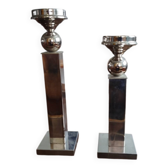Pair of designer candlesticks in chromed metal.