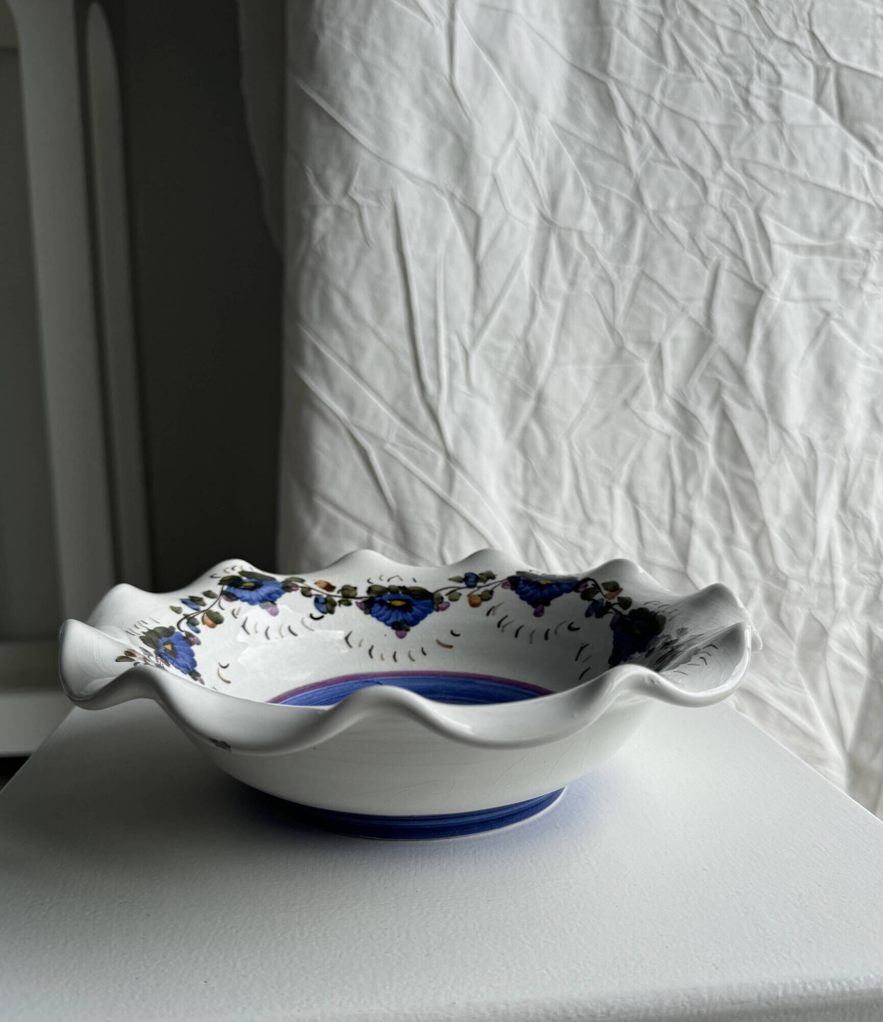 Small hand-painted earthenware salad bowl with garland of blue flowers, mark below