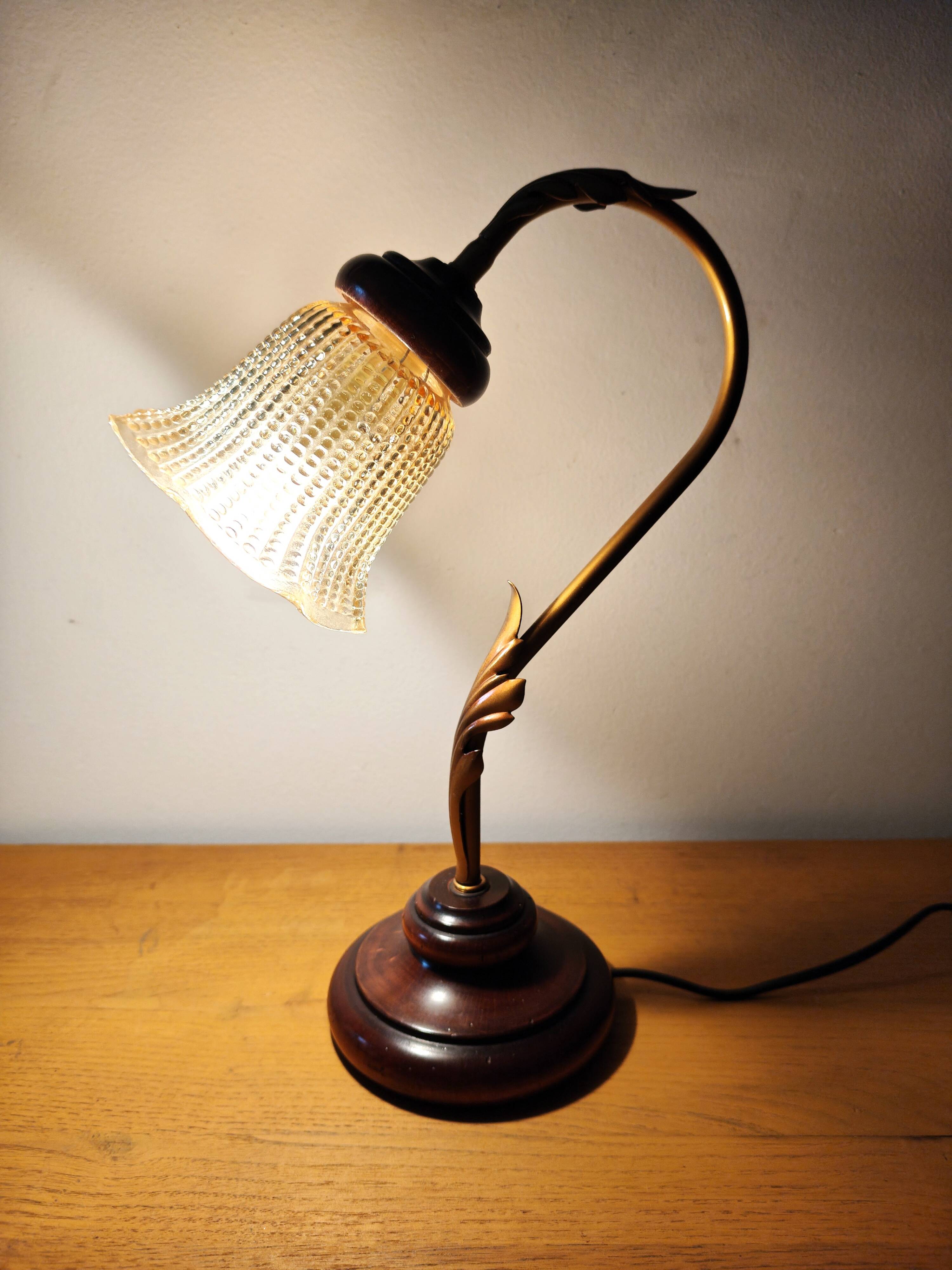 Gold swan neck table lamp with amber tulip glass.