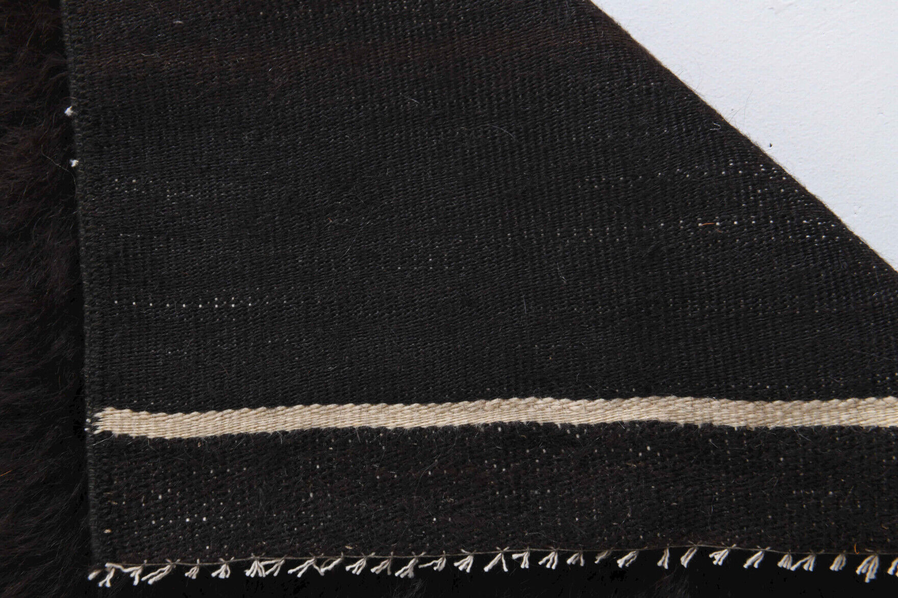 Small vintage flat-woven black rug.