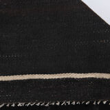 Small vintage flat-woven black rug.