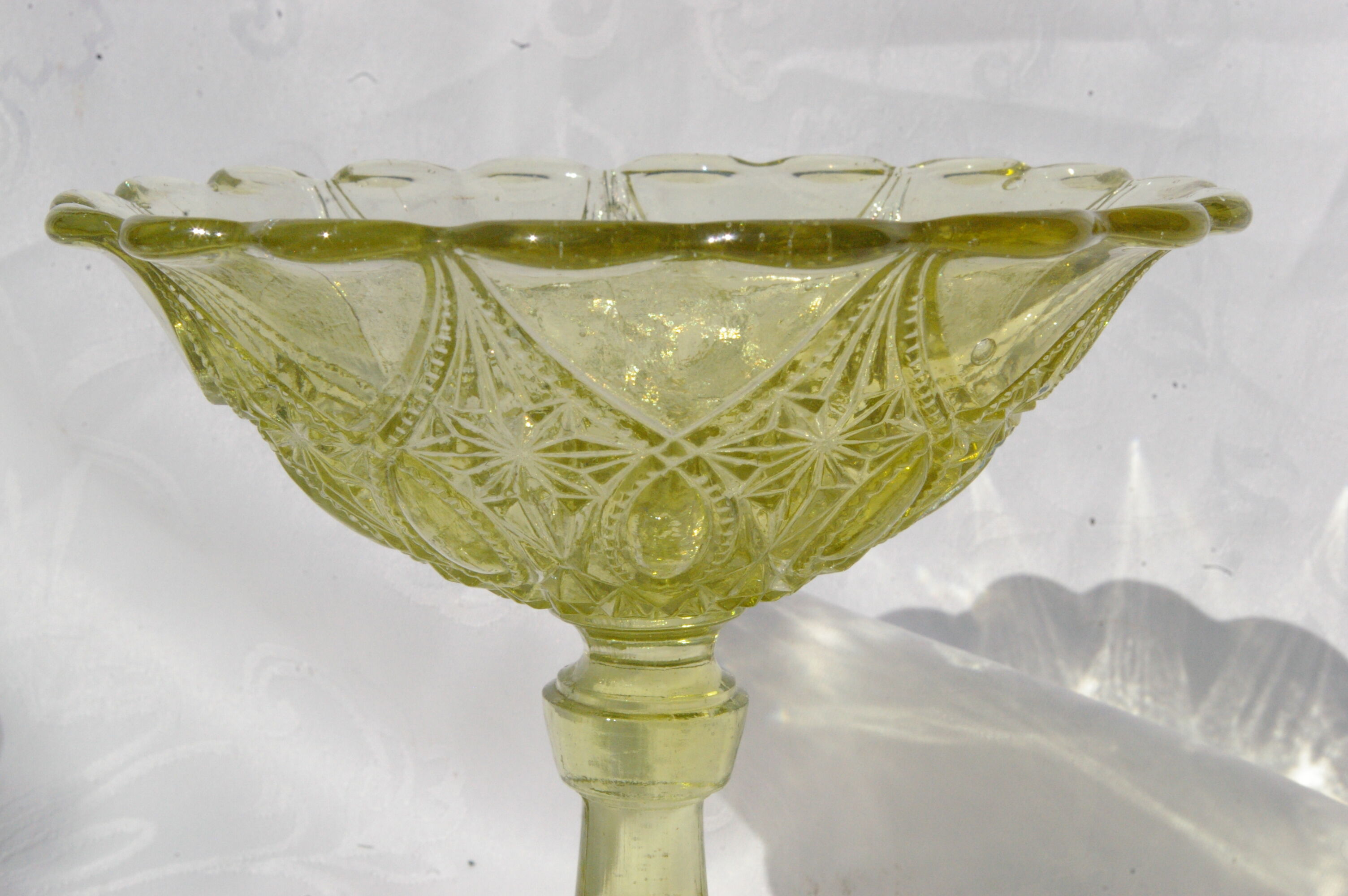 Old small cut on foot in yellow molded glass