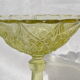 Old small cut on foot in yellow molded glass